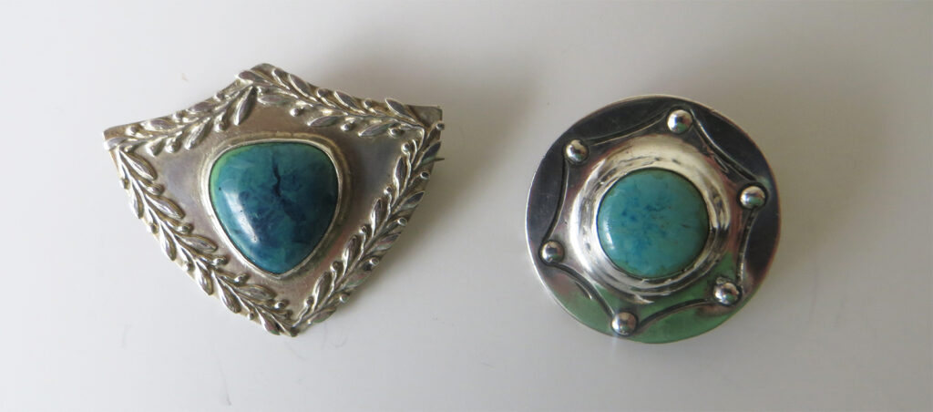A. E. Jones brooches with Ruskin enamels.