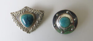 A. E. Jones brooches with Ruskin enamels.