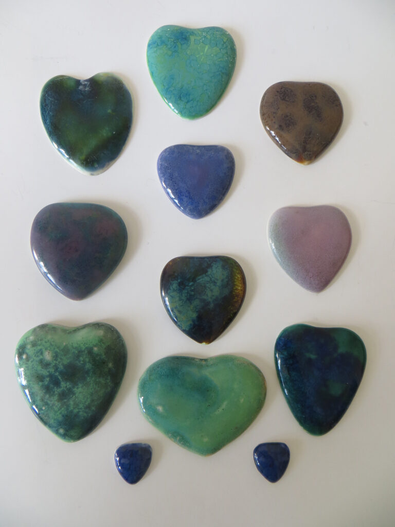 Early Ruskin heart enamels, unmounted.